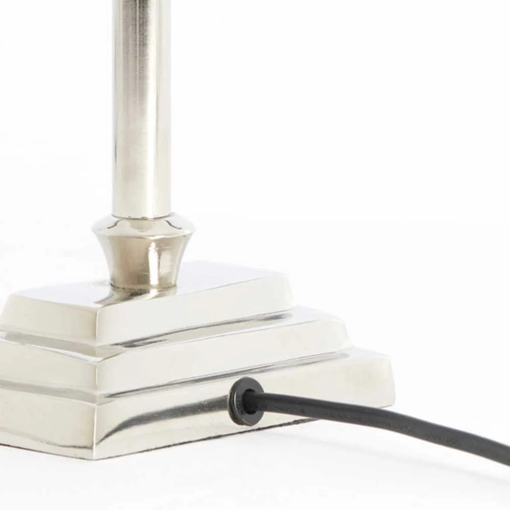 Close-up of the stepped square nickel foot of the KOTA lamp base with the black cord exiting the side