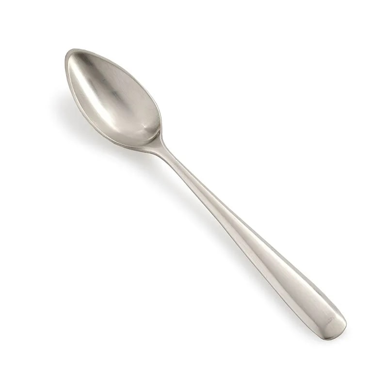 Zoë dessert spoon in matt steel laid diagonally, showing the slim tapered handle and oval bowl