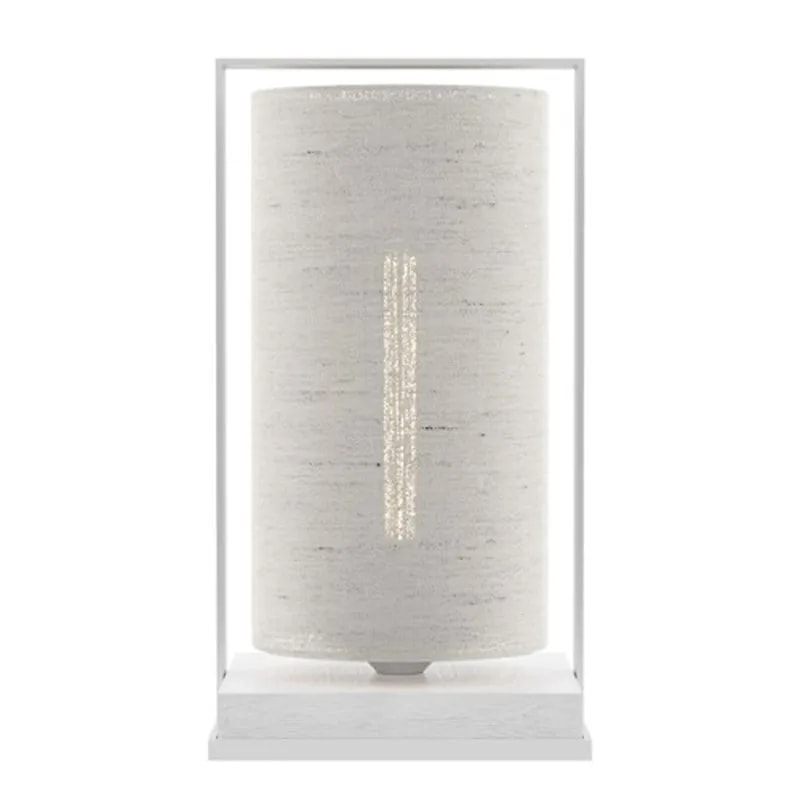 Tube Wood Fabric 40 table lamp with a cream fabric cylinder shade in a white frame and white wood base, softly lit