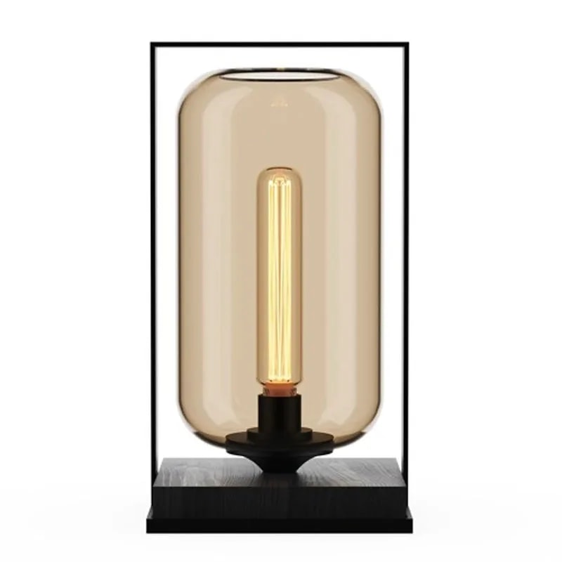 Tube Wood 40 table lamp with an amber glass tube shade in a black frame on a dark wood base, bulb lit, front view