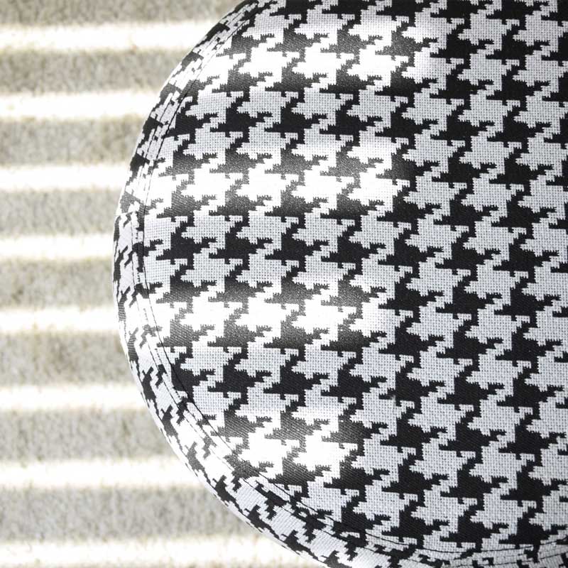 Pouf in upholstered in houndstooth white black